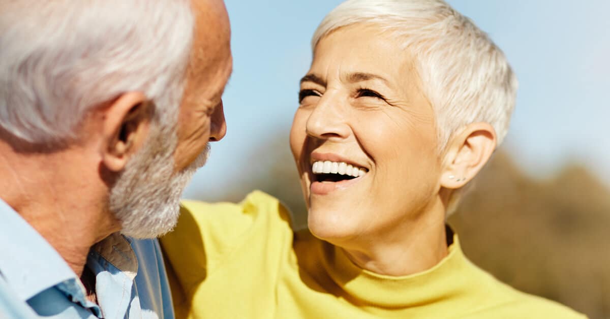 older couple looking at each other with love, bathed in sunlight