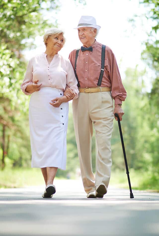 older senior couple walking down a pathway