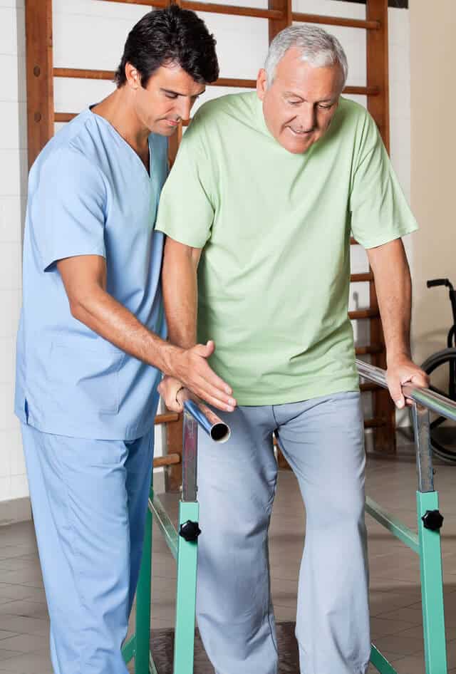 Senior man working on walking exercises with a male physical therapist
